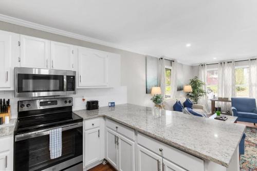 a kitchen with white cabinets and a stove top oven at 21st Street Evergreen Charm in Birmingham