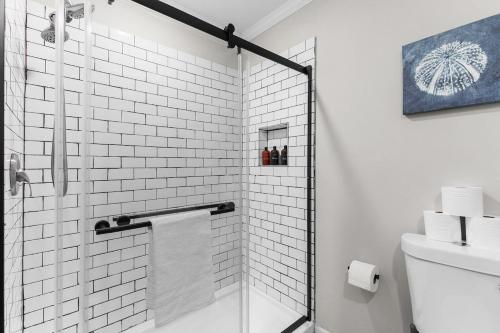 a bathroom with a shower with a glass door at 21st Street Evergreen Charm in Birmingham