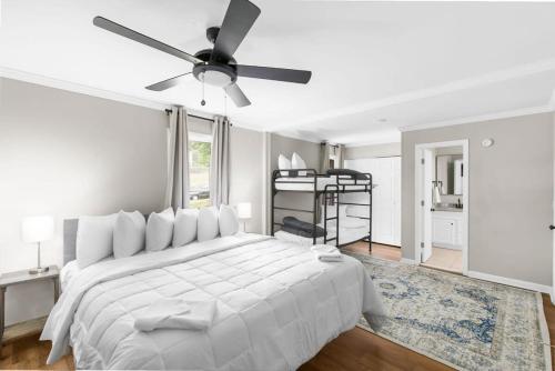 a white bedroom with a bed and a ceiling fan at 21st Street Evergreen Charm in Birmingham