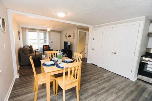 a dining room and living room with a table and chairs at 47th Place Forest Park in Mountain Brook