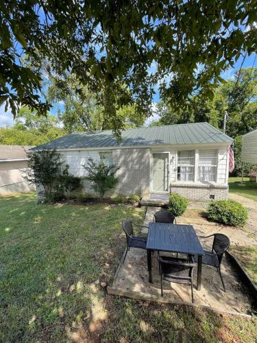 a house with a table and chairs in a yard at 47th Place Forest Park in Mountain Brook