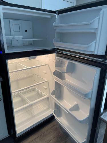an open refrigerator with its door open and its shelves at 47th Place Forest Park in Mountain Brook