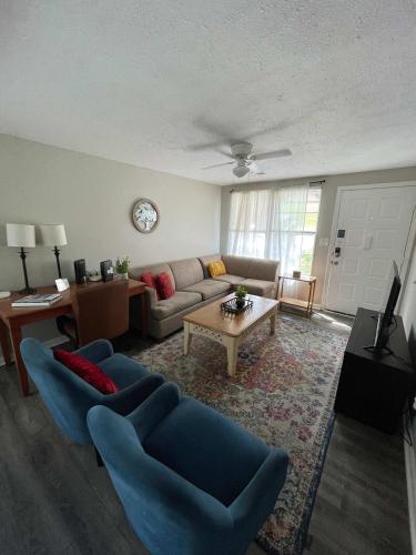 a living room with a couch and a table at 47th Place Forest Park in Mountain Brook
