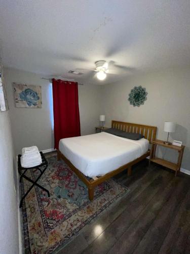 a bedroom with a bed and a red curtain at 47th Place Forest Park in Mountain Brook