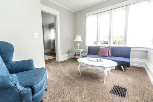 a living room with a blue couch and a coffee table at 29th Street Trendy Lakeview Craftsman 8 in Birmingham