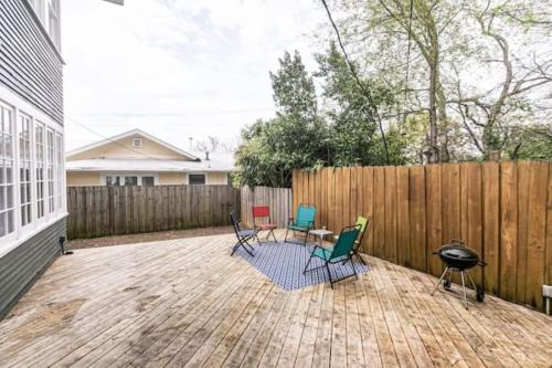 a patio with chairs and a grill and a fence at 29th Street Trendy Lakeview Craftsman 8 in Birmingham