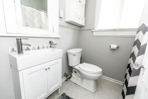 a bathroom with a white toilet and a sink at 29th Street Trendy Lakeview Craftsman 8 in Birmingham