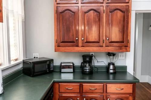 a kitchen with a counter top with a microwave at 29th Street Trendy Lakeview Craftsman 8 in Birmingham