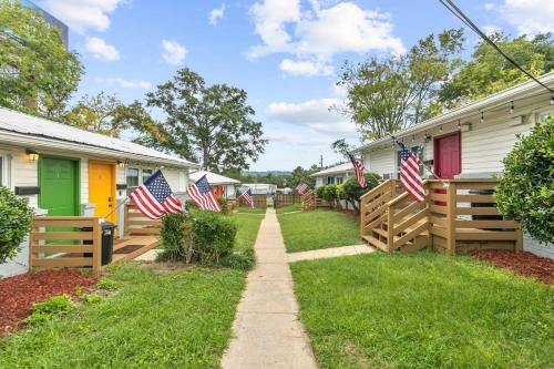 a walkway leading to a row of houses with american flags at 12th Ave The Bricks - Unit 6 in Birmingham