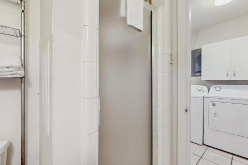 a white laundry room with a washer and dryer at Sunny Days Lake Retreat - Main house in Kingsland