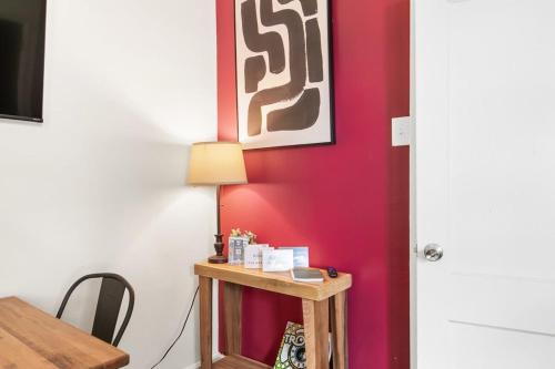 a room with a table and a red wall at 12th Ave The Bricks - Unit 7 in Birmingham