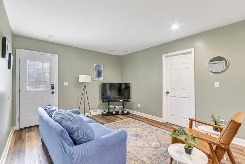 a living room with a blue couch and a tv at Bethany B Huntsville Oasis in Rideout Village