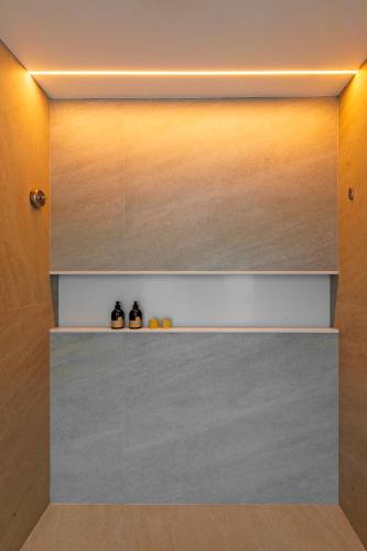 a room with a wall with shelves in it at Zendaya Resort Beach Sport & Spa in Búzios