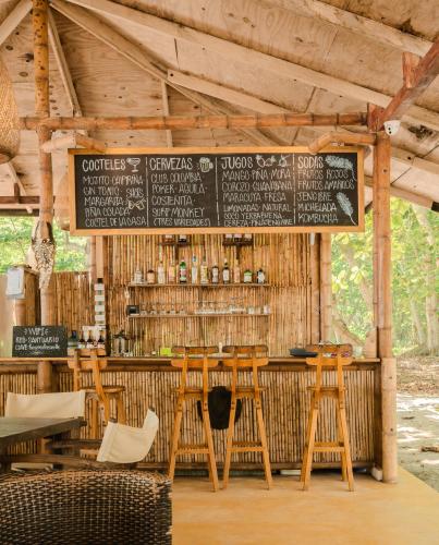 a restaurant with a bar with a sign on it at Hotel Playa Bonita Tayrona in Buritaca
