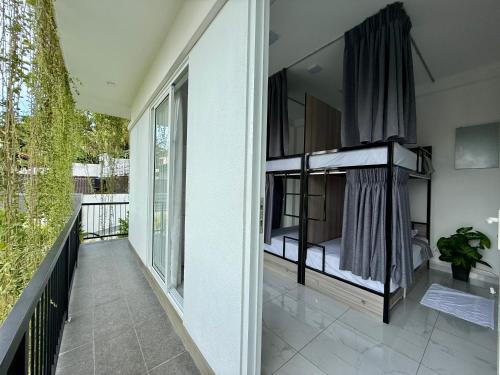 a balcony with two bunk beds on a house at The Bunkyard Galle Hostel in Galle