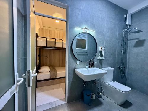 a bathroom with a sink and a mirror at The Bunkyard Galle Hostel in Galle