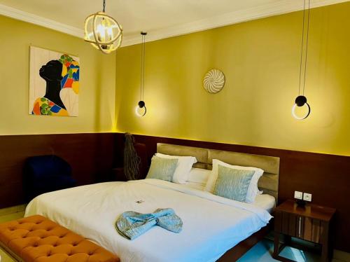 a bedroom with a bed with a bow tie on it at Hotel de l'Air in Douala
