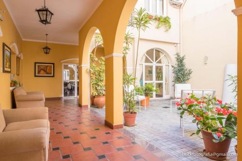 a lobby with potted plants in a building at Delvino Boutique Hotel in Salta