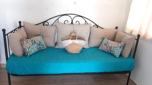 a couch with many pillows and a purse on it at La Terrazza Solarium, in pieno centro 60m dalla stazione ferroviaria 700m dal mare in Santa Flavia
