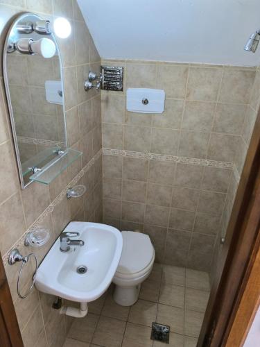 a bathroom with a toilet and a sink at El Rincón De La Playa in Santa Clara del Mar