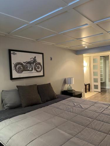 a bedroom with a bed and a motorcycle on the wall at Cottage de style Loft in Saint-Charles-des-Grondines