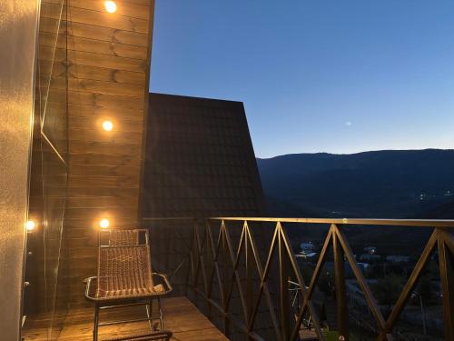 a chair sitting on a balcony with a view at Space Trip Hotel in Artavaz