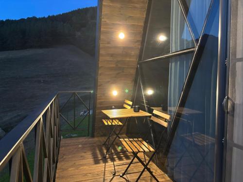 a balcony with a table and a desk on it at Space Trip Hotel in Artavaz