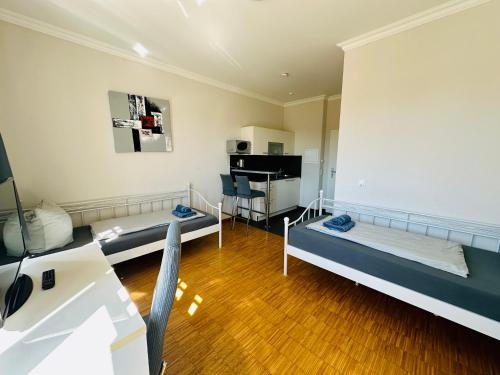 a living room with two beds and a table at Apartmenthouse Singen in Singen