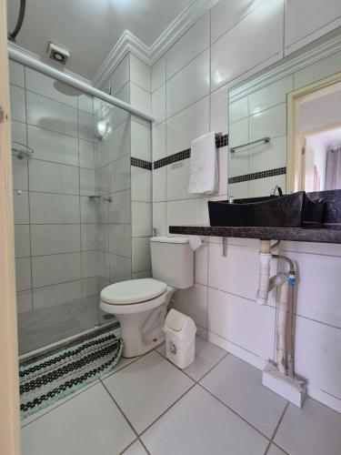 a bathroom with a toilet and a shower and a sink at 605 SEVILHA in Serra
