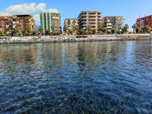 a large body of water with buildings in the background at GIOIA Holiday Home in Torre del Greco
