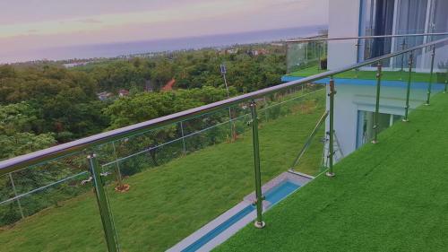 a balcony of a house with a swimming pool at Villa Carlito in Las Terrenas