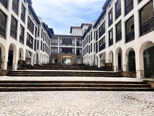 a row of buildings with stairs in a courtyard at Къща за гости Белора in Dryanovo