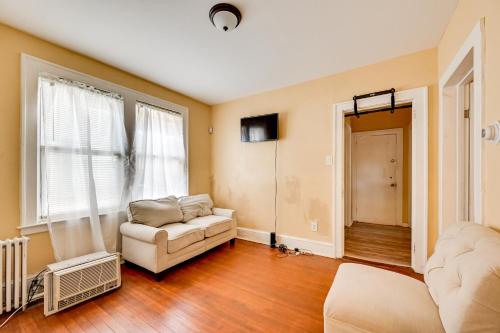 a living room with a couch and a window at Convenient Hartford Condo Less Than 2 Mi to Dtwn! in Stowe Village Housing Project