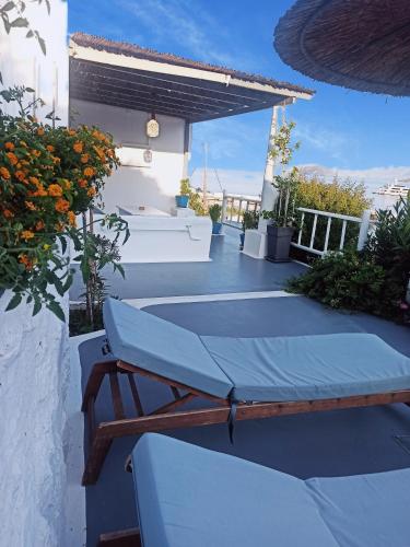 a patio with a table and a bench on it at Bella Vista in Panteli