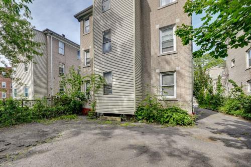 an empty parking lot in front of a building at Convenient Hartford Condo Less Than 2 Mi to Dtwn! in Stowe Village Housing Project