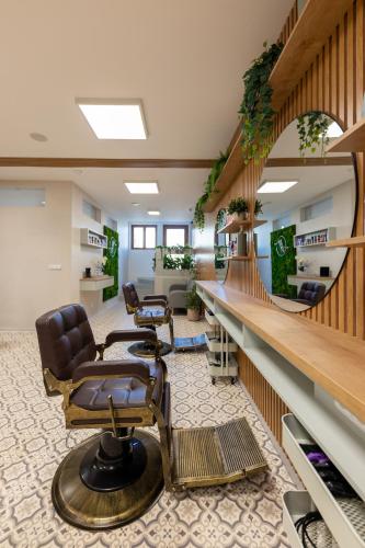 a salon with a barber chair and a mirror at VOUSATÁ DÁMA - PS3 - Parking free in Prague