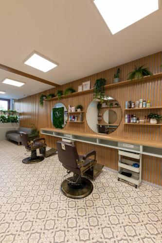 a hair salon with two chairs and a mirror at VOUSATÁ DÁMA - PS3 - Parking free in Prague