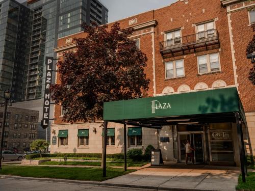 a building with a green awning in front of it at The Plaza Hotel - Milwaukee in Milwaukee