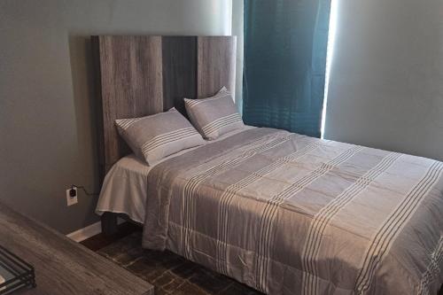 a bed with white sheets and pillows in a room at The Village in Atlanta
