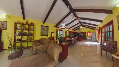 a living room with couches and a dining room at Villa Amable, Lujo entre Selvas y Lagunas in Akumal