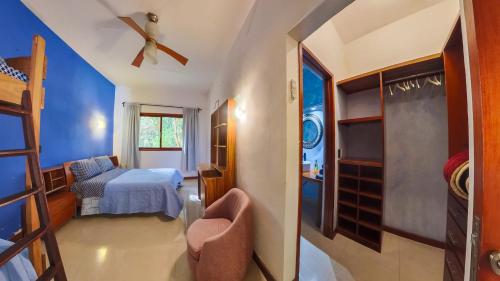 a bedroom with a bed and a ceiling fan at Villa Amable, Lujo entre Selvas y Lagunas in Akumal