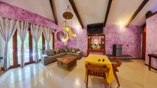 a living room with a couch and a table at Villa Amable, Lujo entre Selvas y Lagunas in Akumal