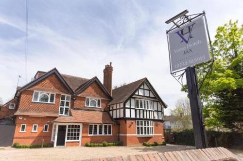 a house with a sign in front of it at Verve Hotel in Bedford