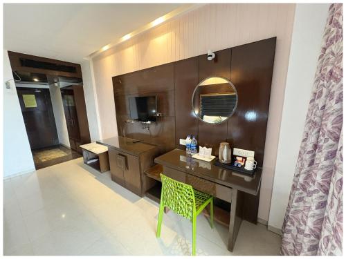 a bathroom with a sink and a desk with a mirror at Private Beach Hotel Golden Palace with Swimming Pool in Puri in Puri