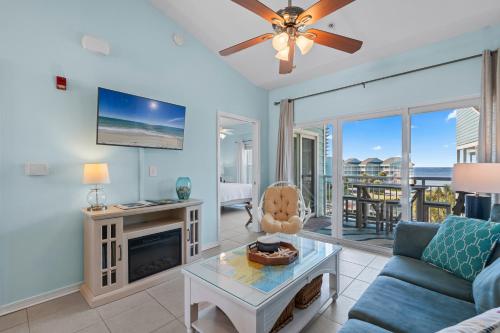 a living room with a couch and a tv at Baywatch Unit G9 in Pensacola Beach