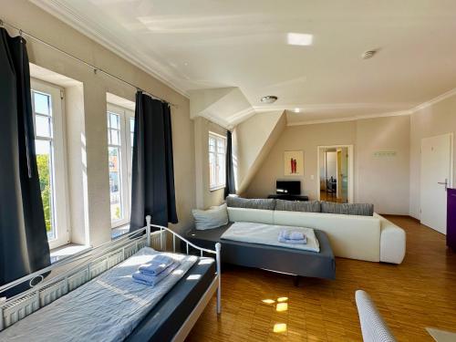 a living room with two beds and a couch at Apartmenthouse Singen in Singen