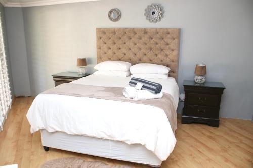 a bedroom with a bed with a suitcase on it at Serene living in East London