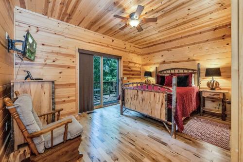 a log cabin bedroom with a bed and a window at Our Place to Paws 4 Bd Lux Blue Ridge Mnt Cabin in Lansing