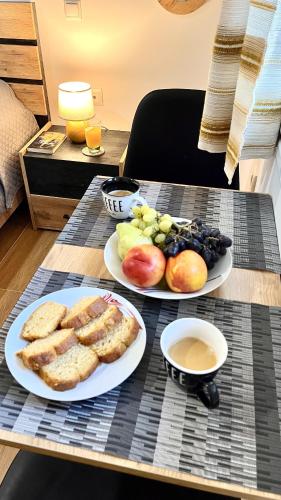 two plates of bread and fruit on a table at Elina's Rooms in Poros