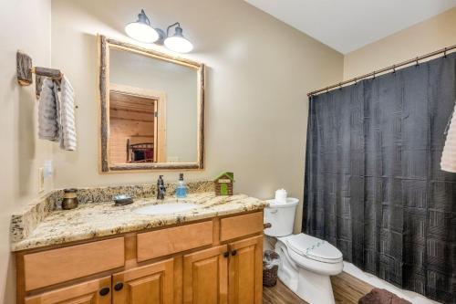a bathroom with a sink and a toilet and a mirror at Our Place to Paws 4 Bd Lux Blue Ridge Mnt Cabin in Lansing